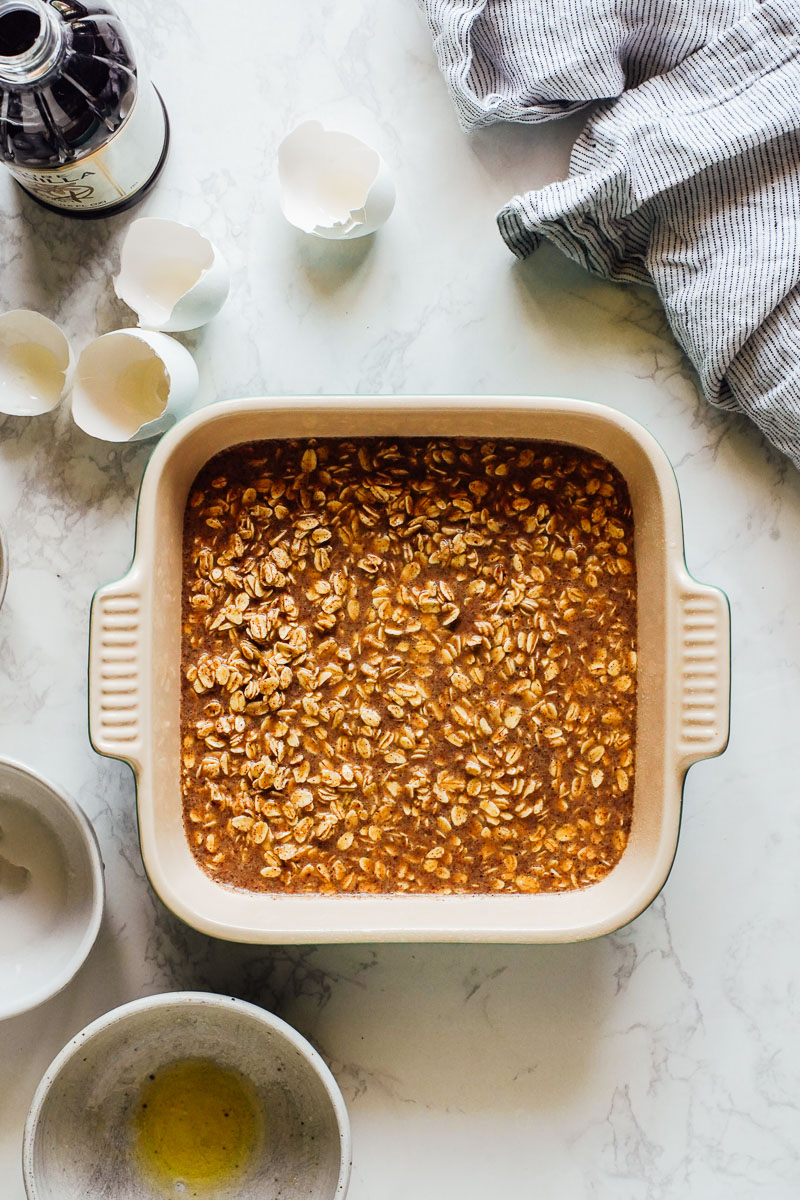 Baked oat mixture resting in the baking pan before cooking.