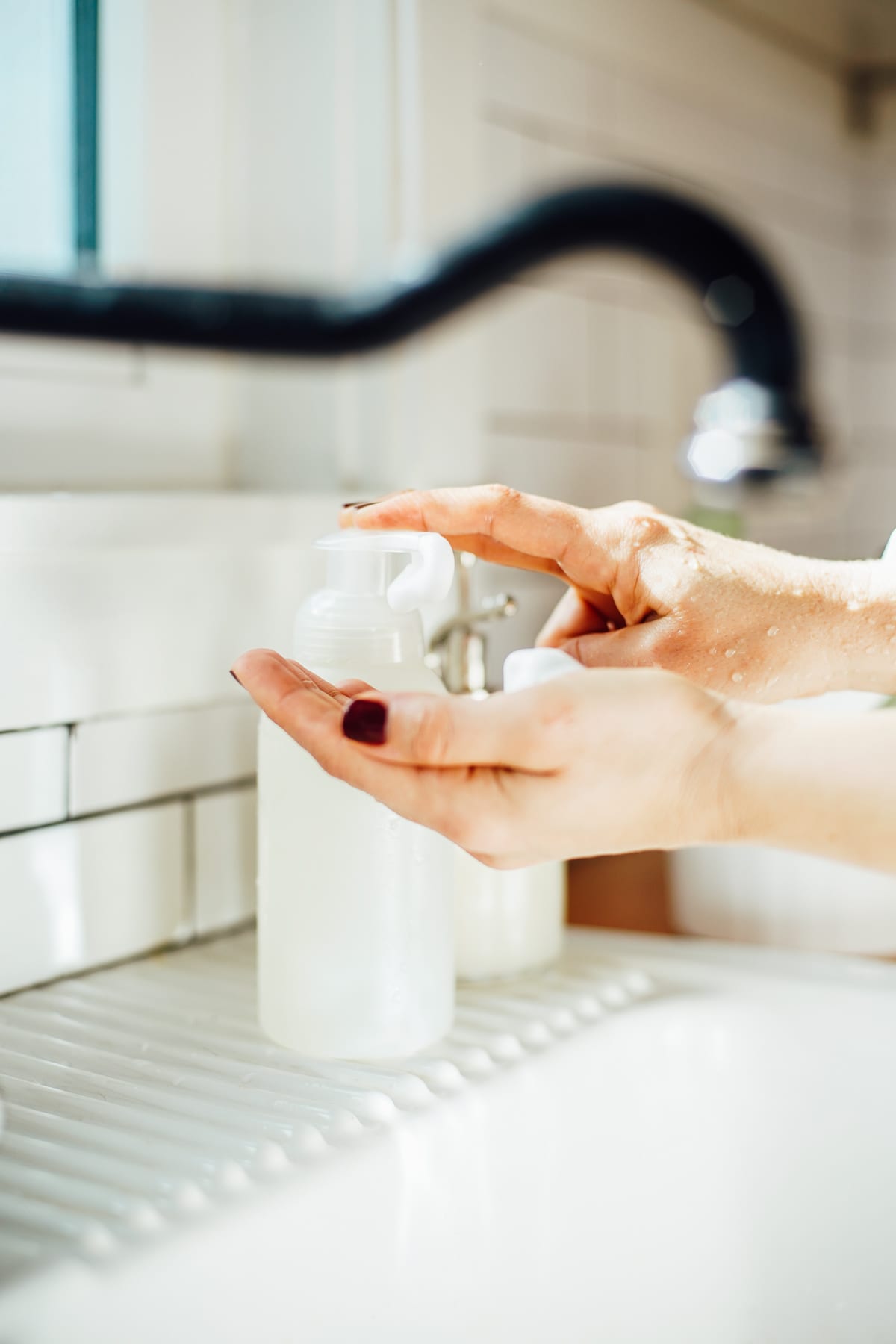 Using the hand soap to wash hands