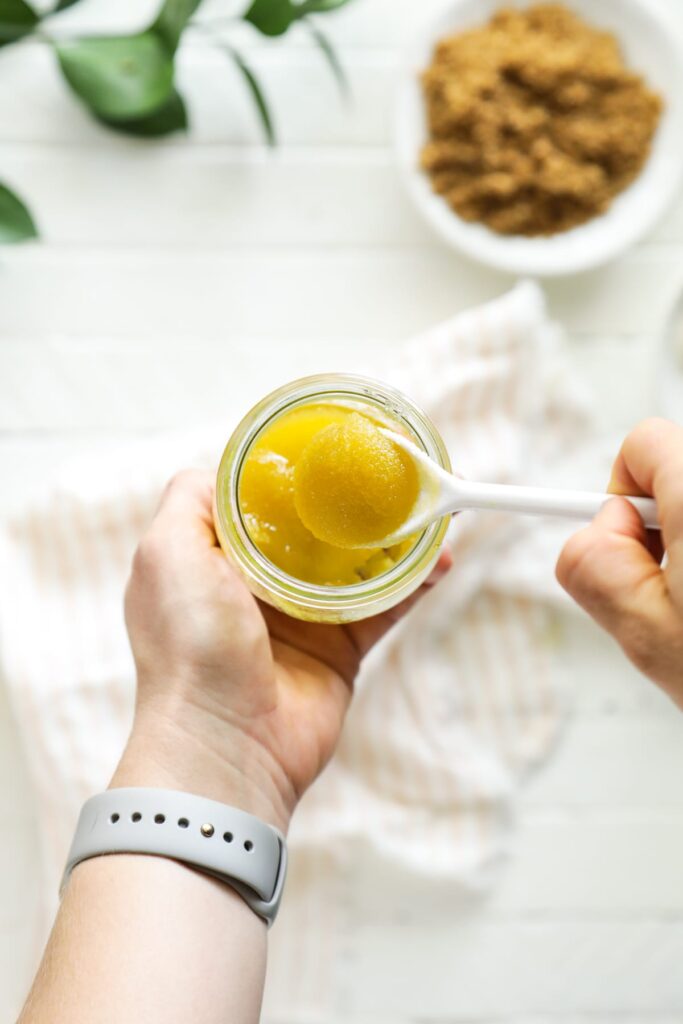 Stirring together the sugar and oil to make a lip scrub. 