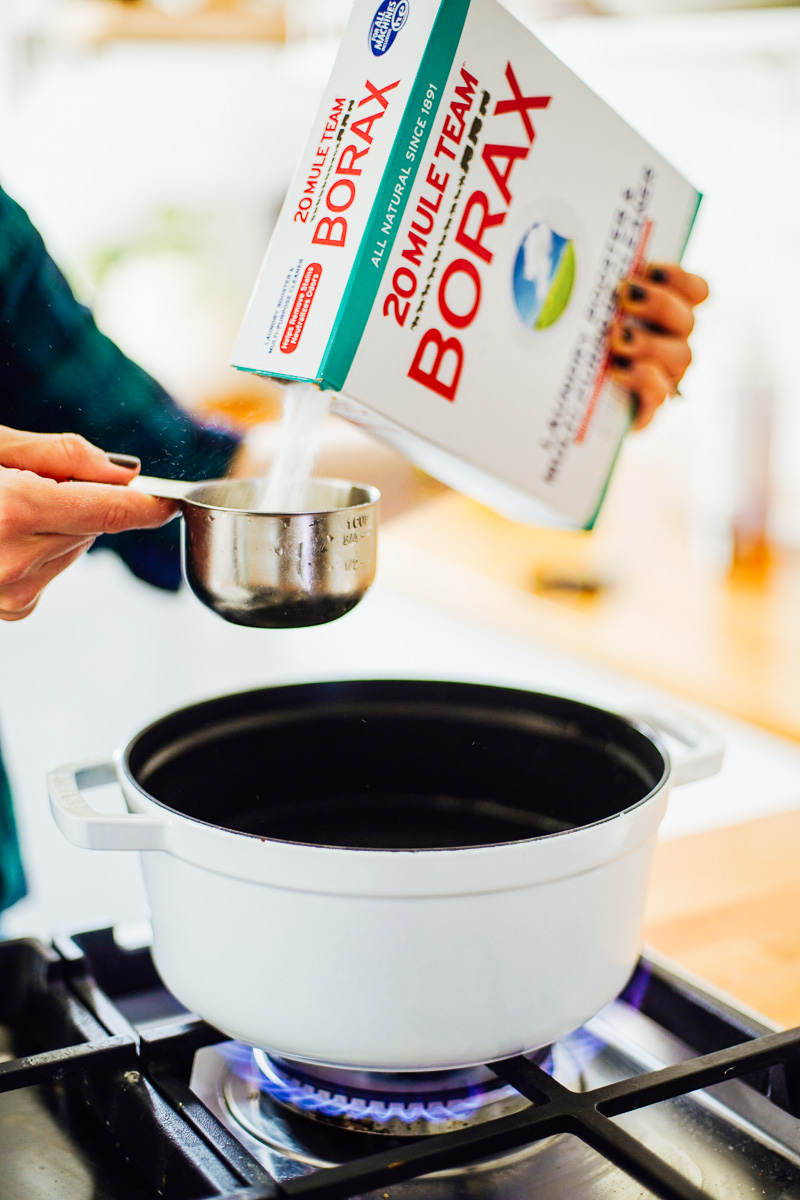 Pouring Borax into the dutch oven.