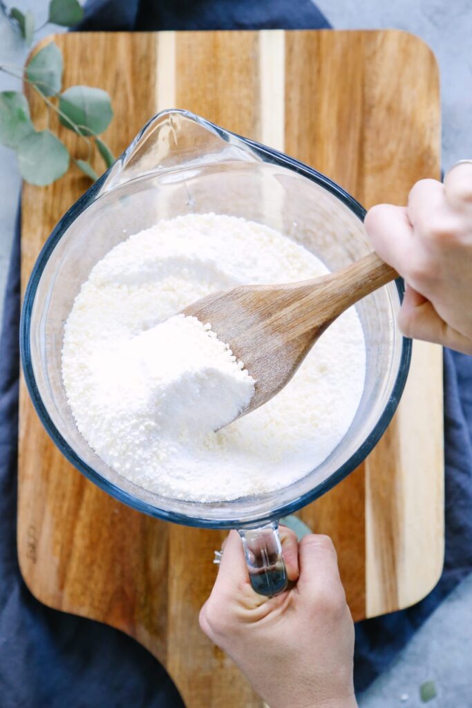 Mixing borax with the other ingredients in a large bowl.