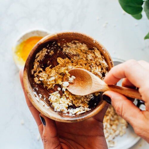 Combining the ingredients to make an oatmeal face mask.