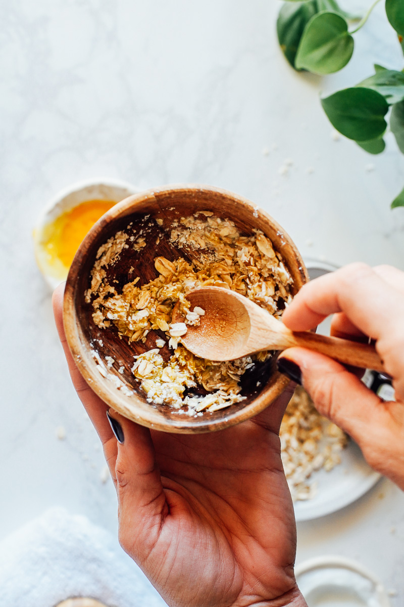 Combining the ingredients to make an oatmeal face mask.