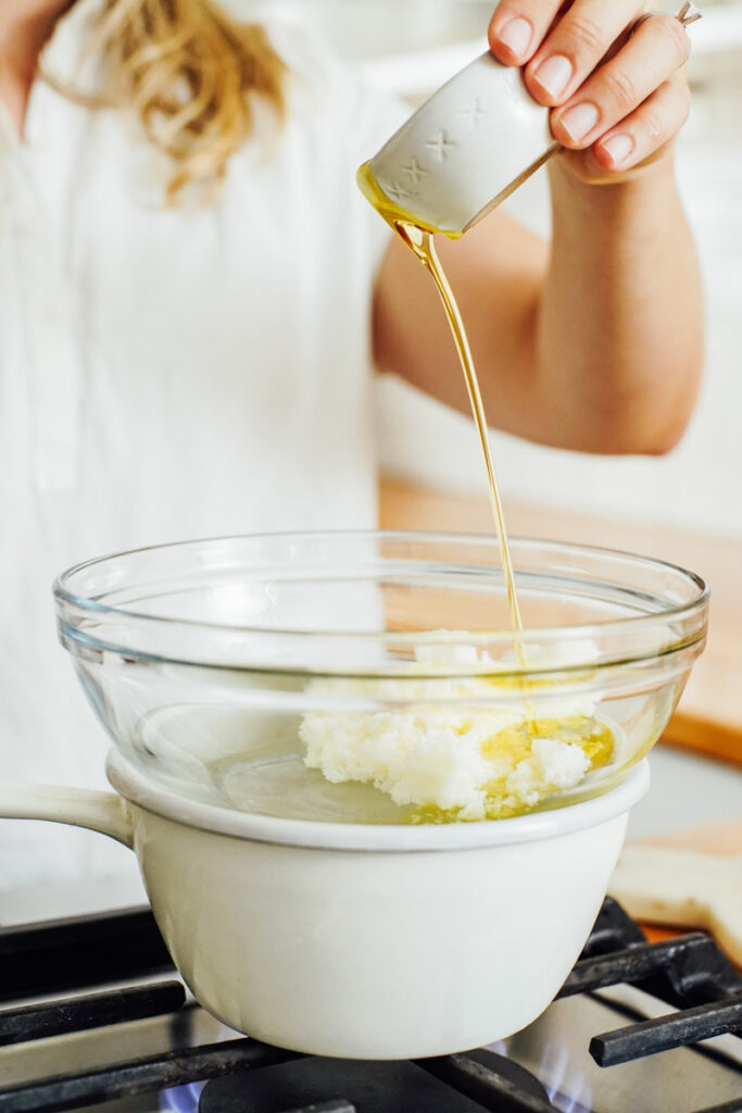 Adding oil to a double boiler. 