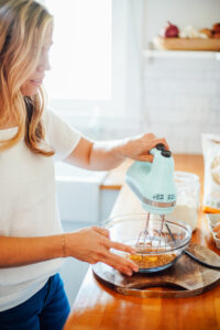 Creaming butter, brown sugar, and cane sugar in a large bowl with a handmixer.