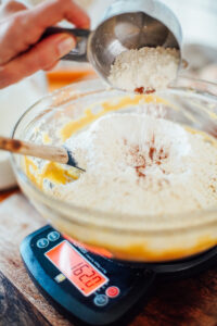 Weighing the flour with the dry ingredients.