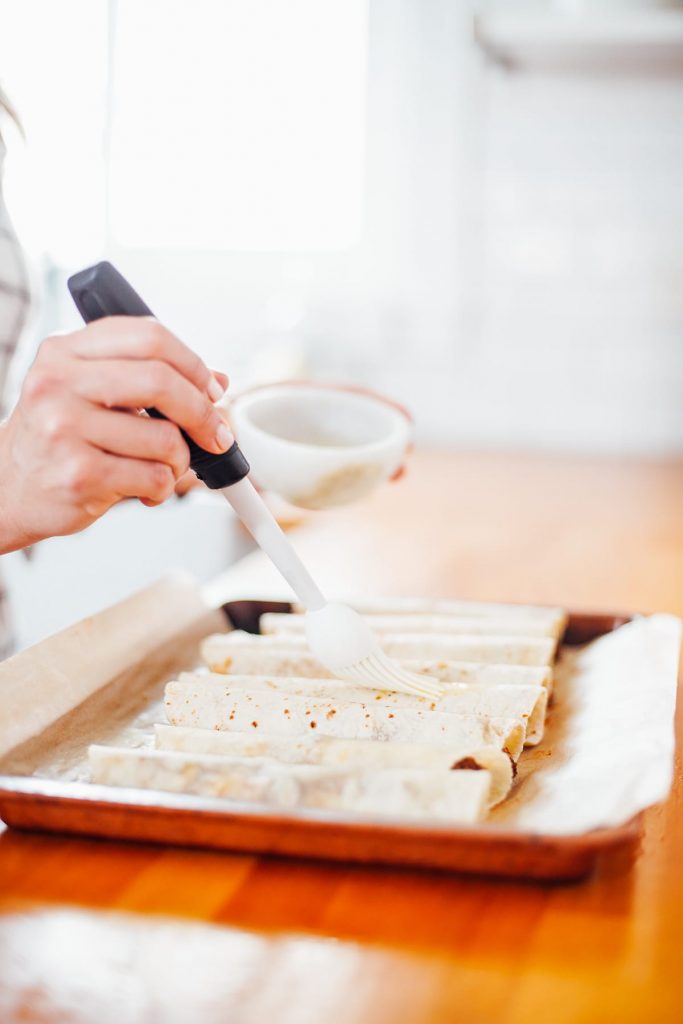 brushing taquitos with oil 