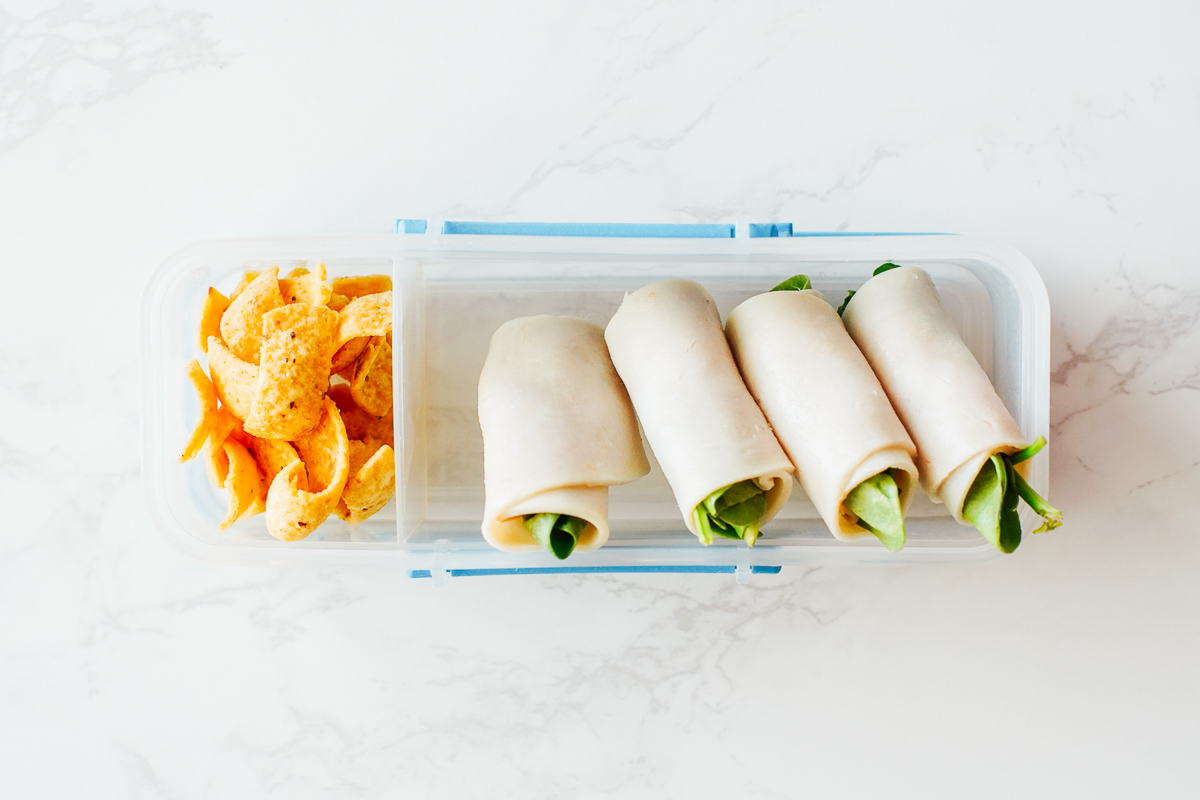 Rolled up turkey with cheese and spinach, tortilla chips. 