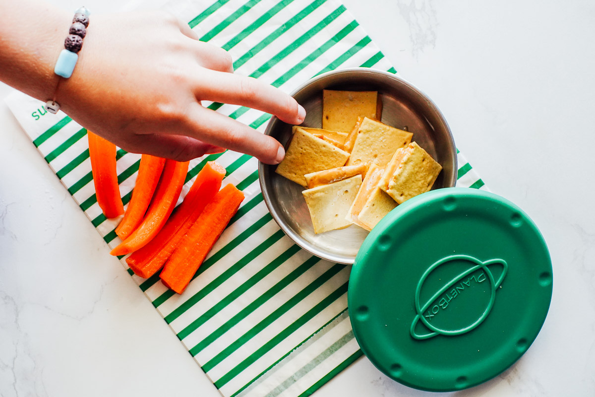 Peanut butter spread on crackers and carrots.  