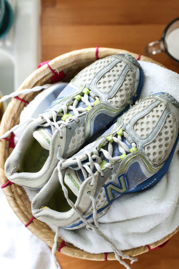 Dirty sneakers in a laundry basket. 