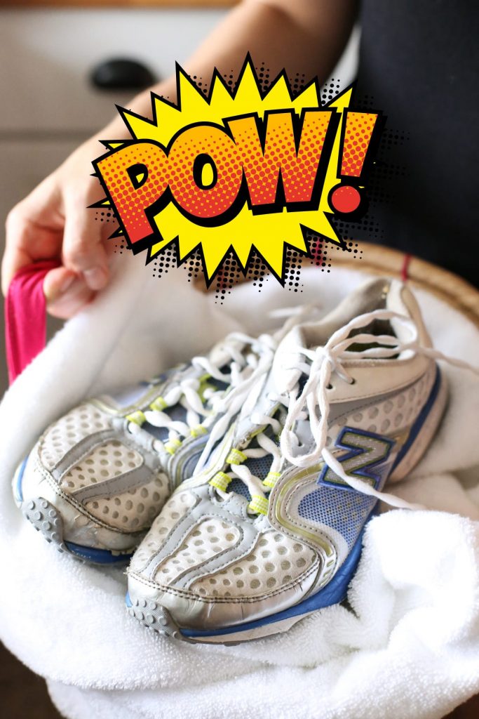 Clean, white and bright sneakers in a laundry basket. 