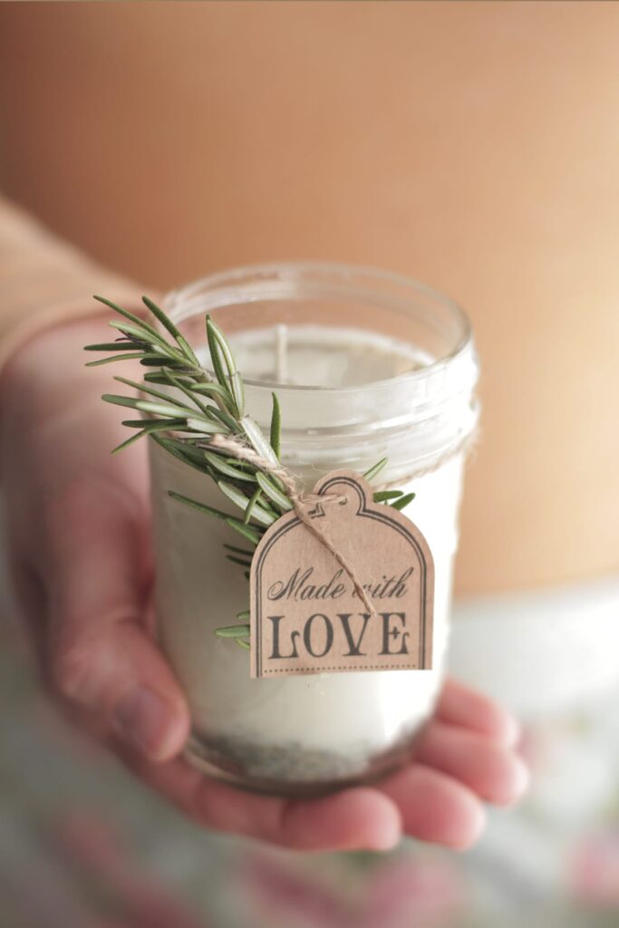 Hand holding a poured soy wax candle.