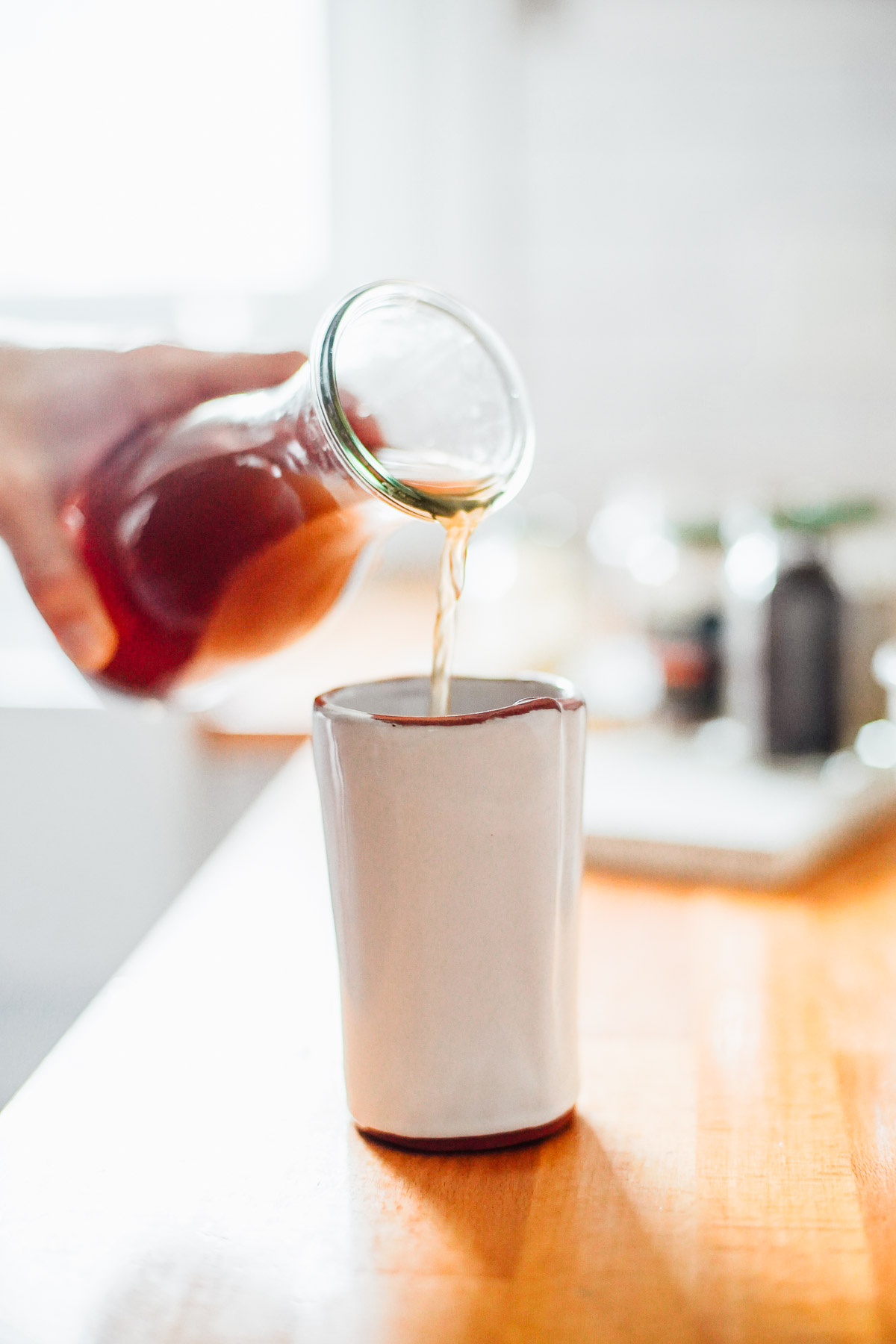 Pouring the chai concentrate into a mug.