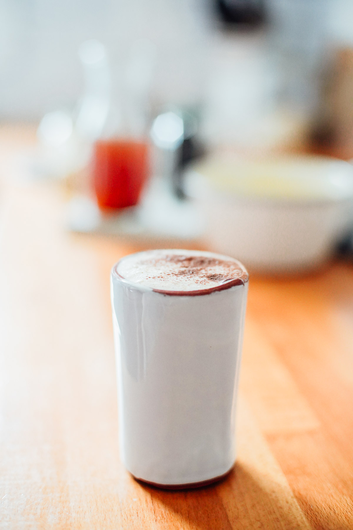 Chai latter on a countertop with the concentrate in the background.