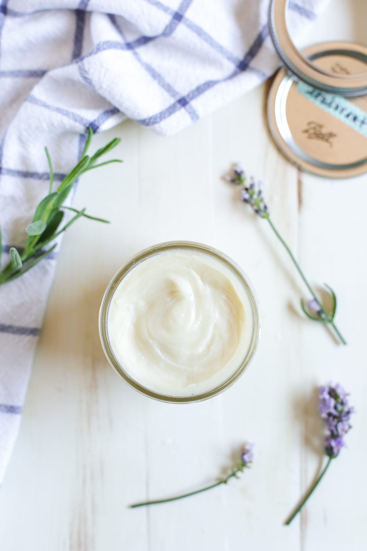 Homemade deodorant on a countertop in a glass jar. 