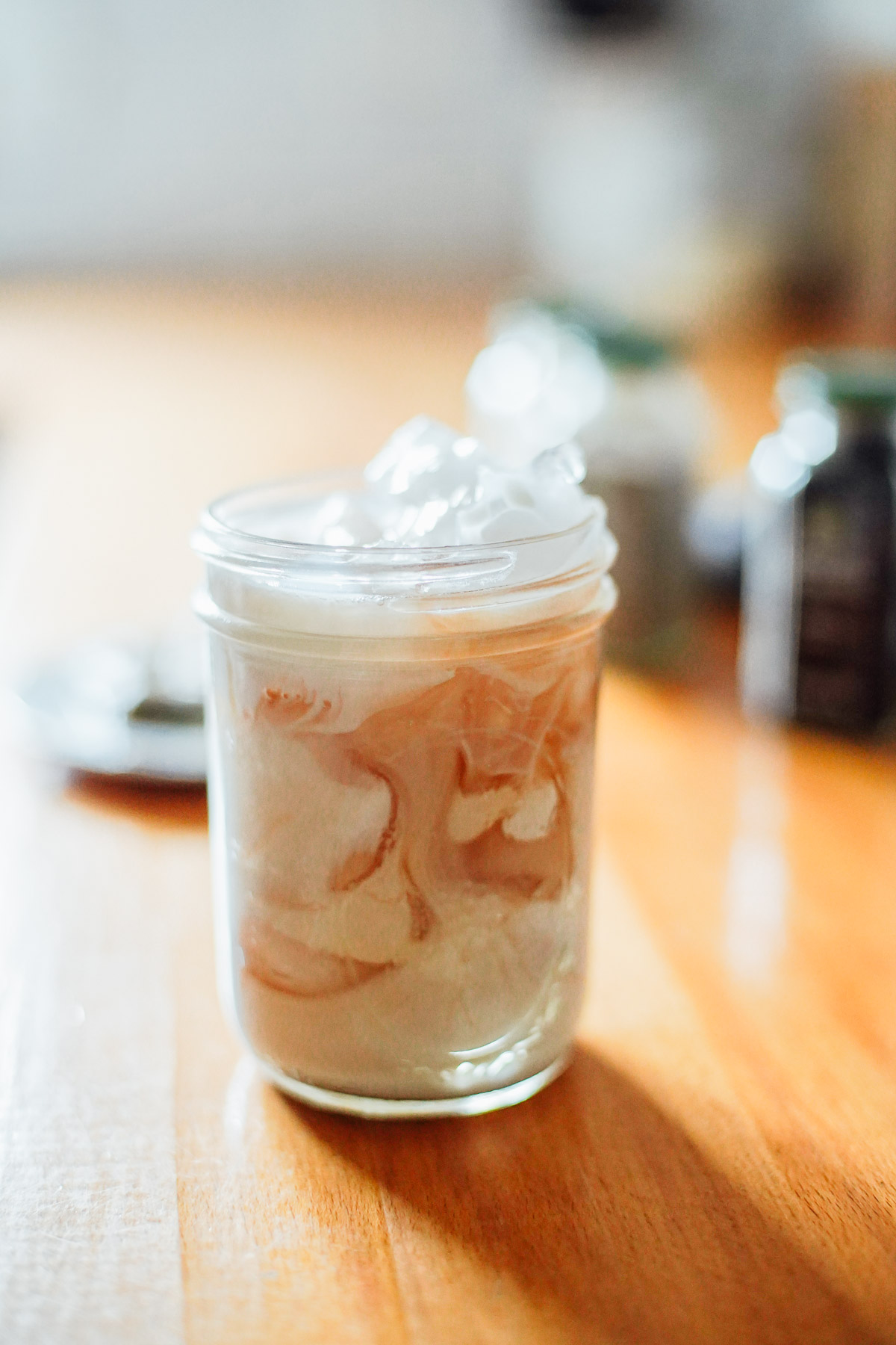 Chai latte in a mason jar filled with ice.