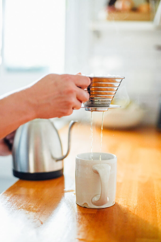 Brewing the coffee using a single serve pour over coffee machine. 