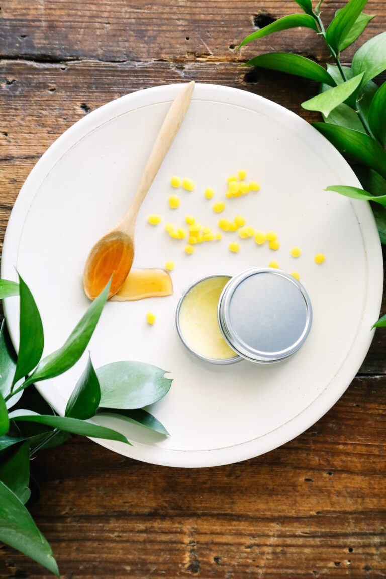 Honey lip balm on a plate with honey and beeswax