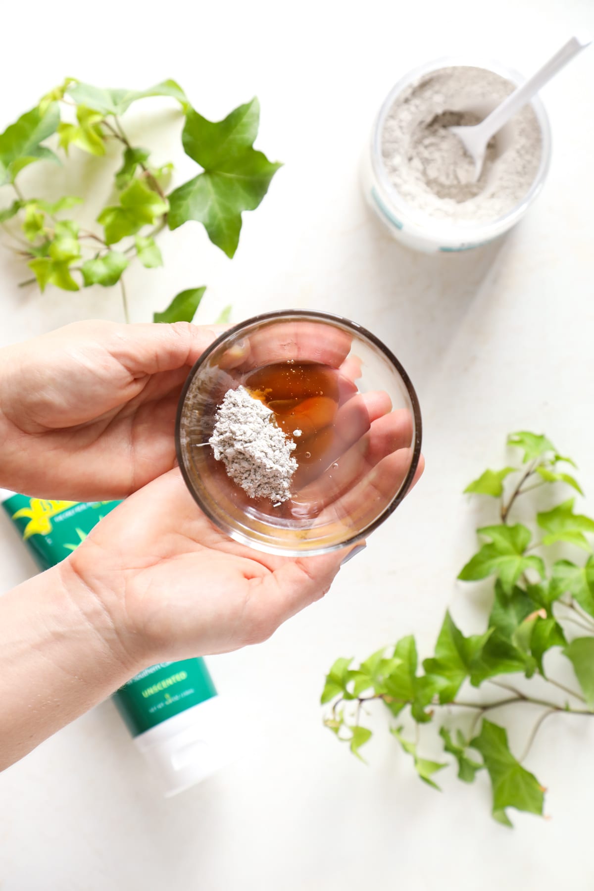 Aloe, honey, and clay in a bowl to make a face mask.