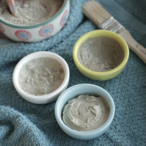 3 homemade clay face masks in bowls on the counter.