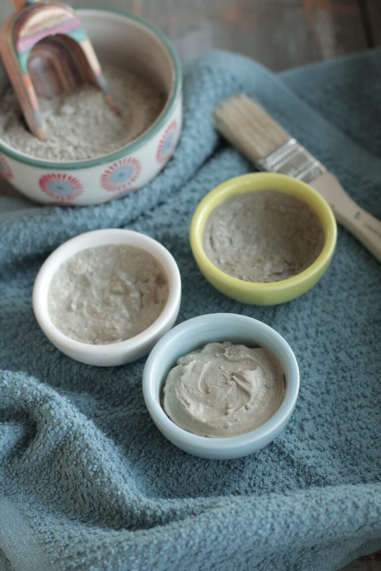 3 homemade clay face masks in bowls on the counter.