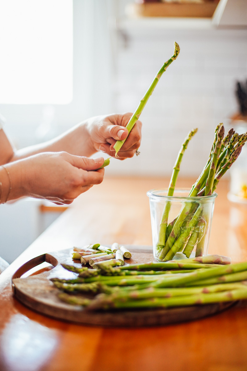 Breaking off the woodsy ends of the asparagus stem with my hand.