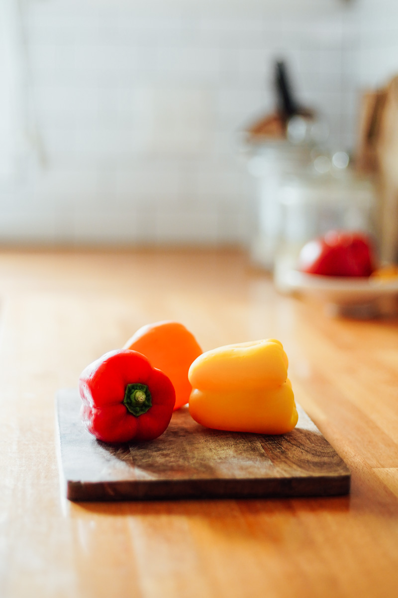 bell peppers on a cutting board in the kitchen.