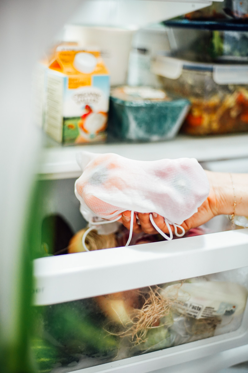 Placing bell peppers inside a reusable cloth bag in the crisper drawer in the fridge.