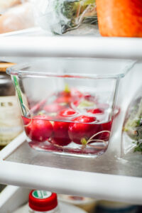 Radishes stored in a glass jar with water added to submerge the radishes.