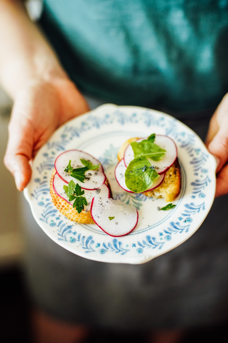 Radish toast: radish slices on a slice of sourdough toast with butter on a blue plate.