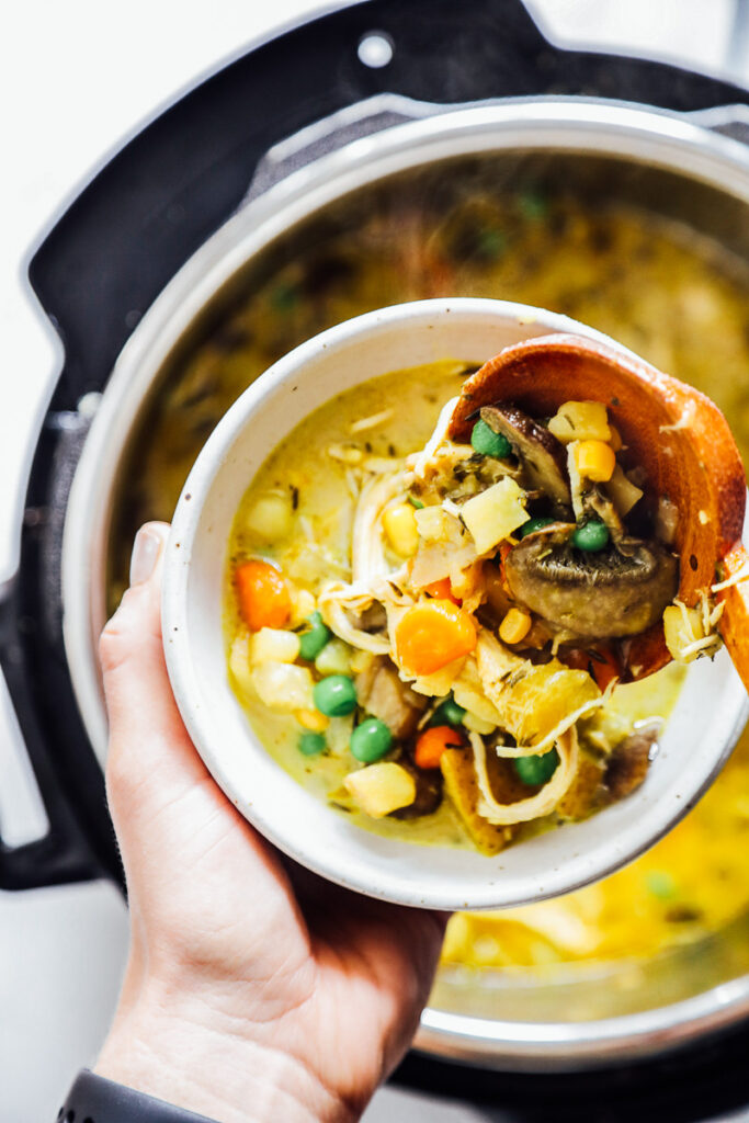 Spooning soup into a bowl from the Instant Pot.