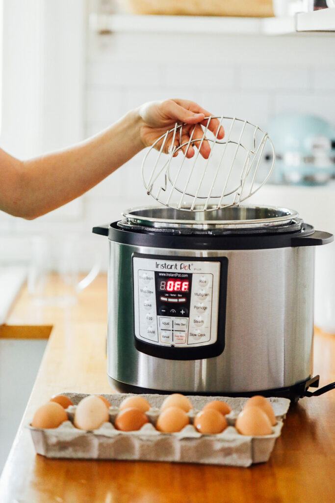 Placing the trivet rack inside the Instant Pot.