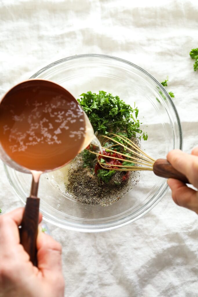 Whisking the gravy ingredients in a bowl. 