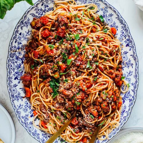 Plated pasta with bolognese sauce mixed together.