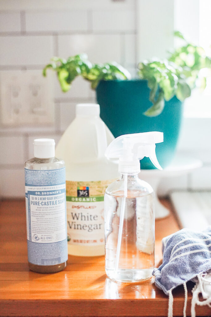 All purpose cleaner in a clear glass bottle on the countertop in the kitchen.