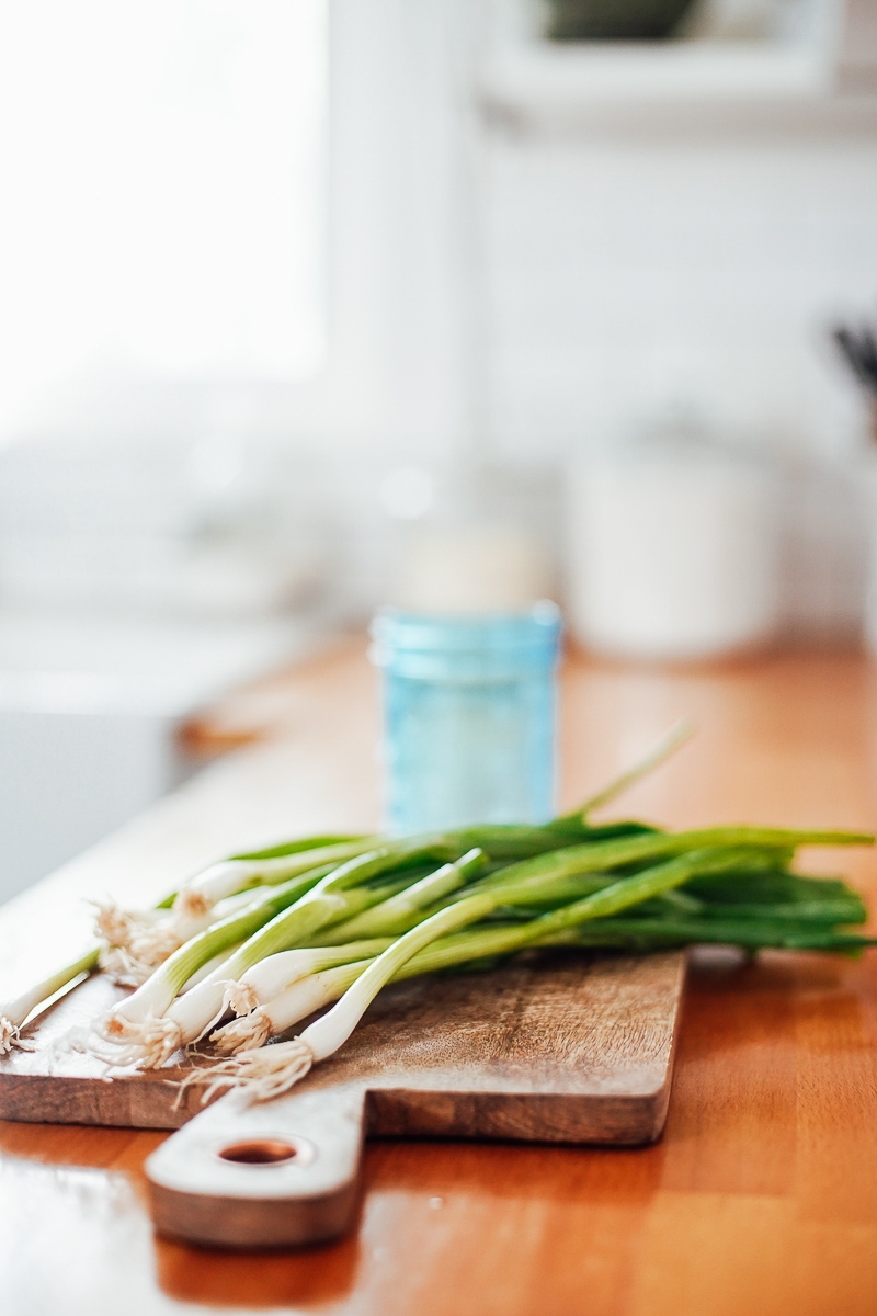 Green onions on a cutting board. 