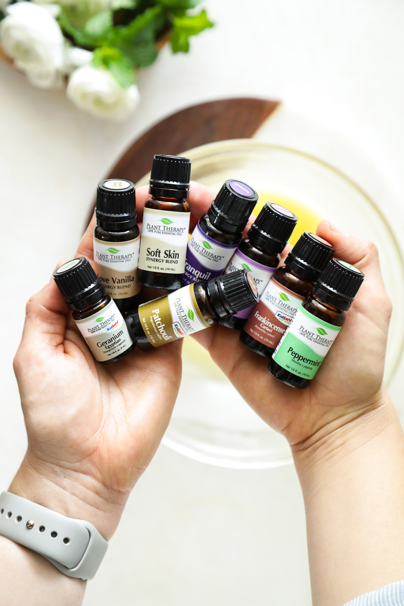 Holding essential oil bottles in hands.