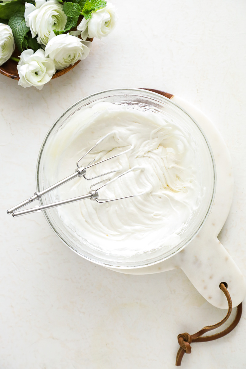 Using a hand-mixer and beaters to whip the body butter mixture.