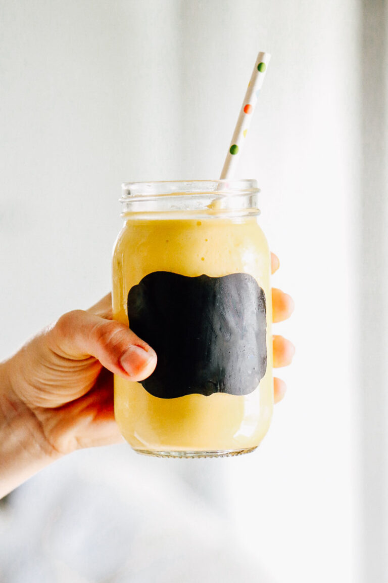 Mango pineapple smoothie in a glass mason jar.