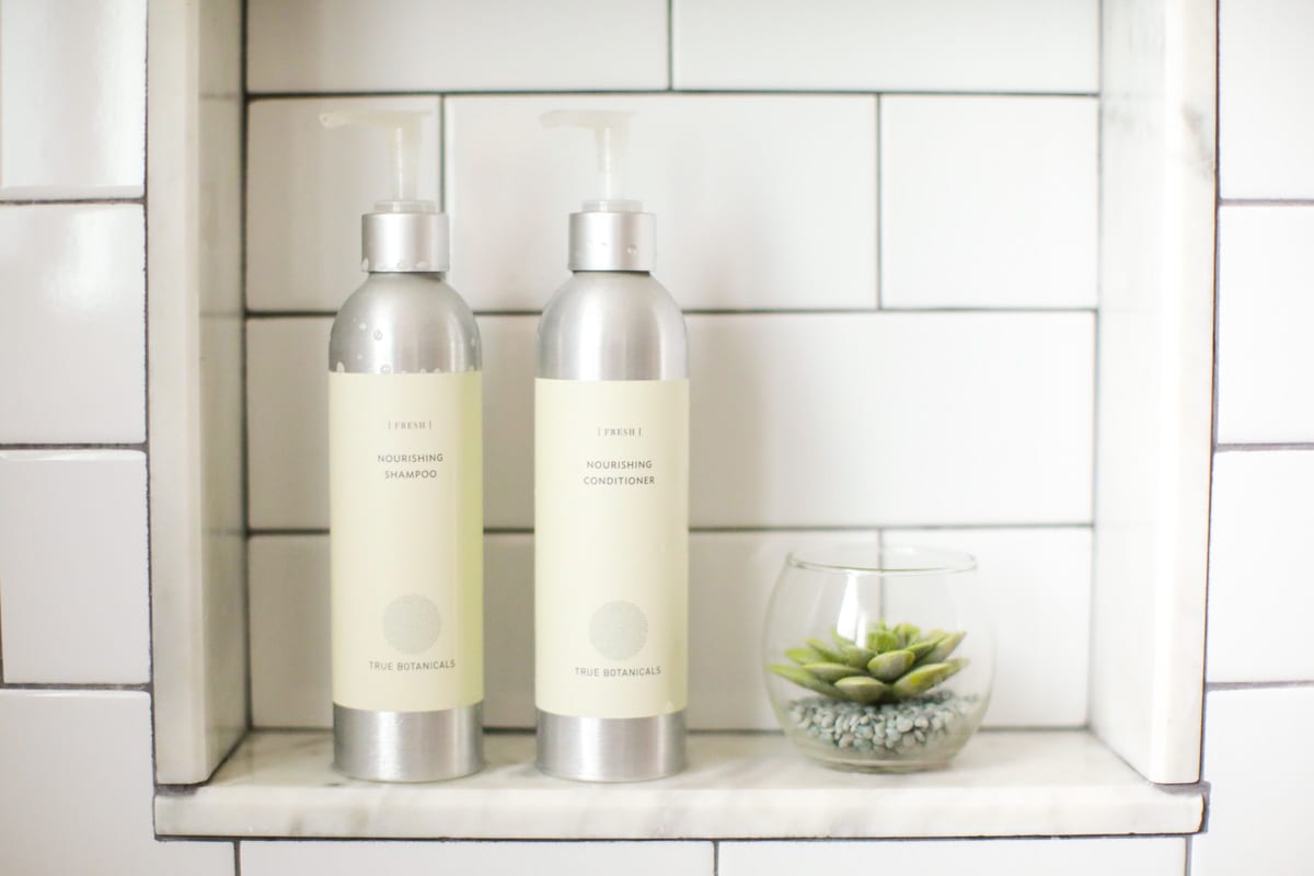 True botanicals shampoo and conditioner in the bathroom.